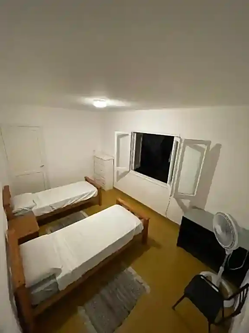 Double room at Ballario Guest House with two single beds and a window